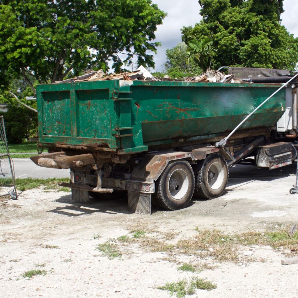 Roll Off Dumpster being picked up from a truck